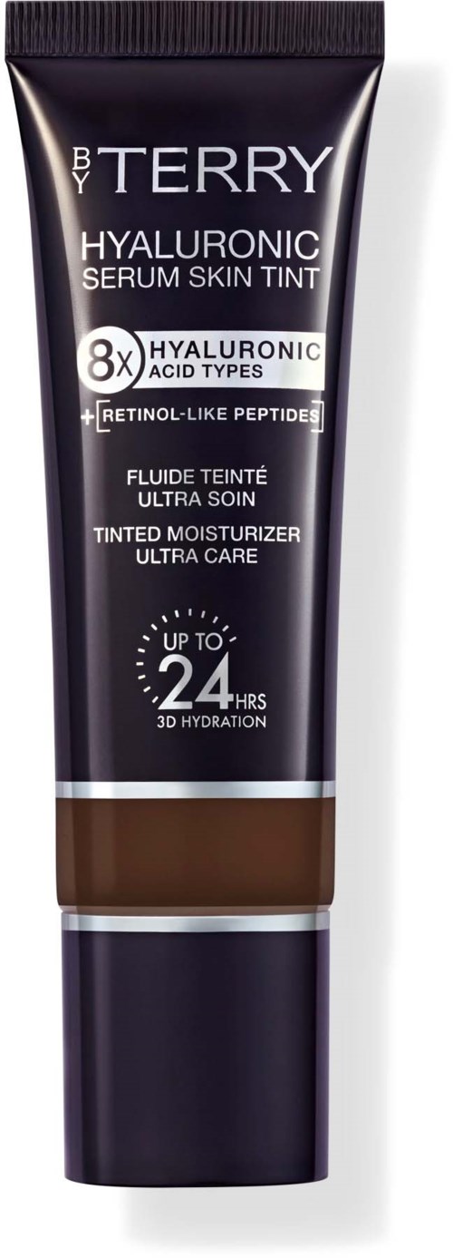 En svart tub av B By Terry Hyaluronic Serum Skin Tint med vitt text och en brun färg upptill.