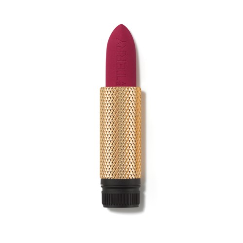 A lipstick with a pink tip and a gold textured case, standing upright on a white background.