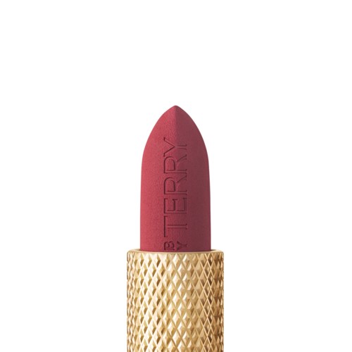 A lipstick with a gold textured case and deep red color. The lipstick is slightly pointed at the tip.