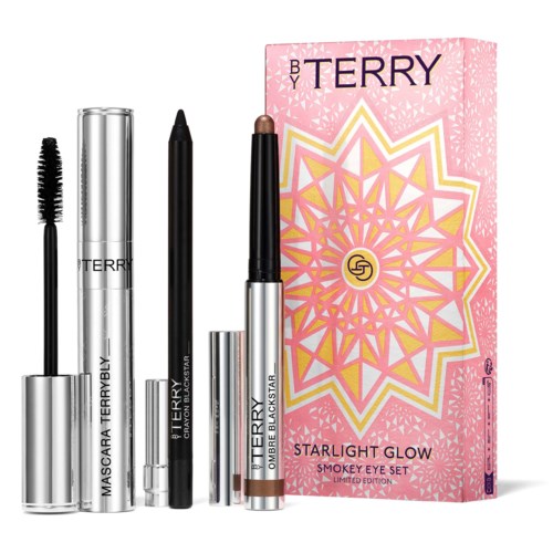 Makeup products and a pink box with a geometric design, labeled 'Starlight Glow' and 'Smokey Eye Set.'