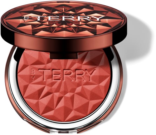En rund sminkeompakt med et geometrisk mønster på lokket og blush inni. Merket "BEAUTY TERRY" er synlig.