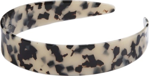 A headband with a black and white spotted pattern. It is curved to fit around the head.