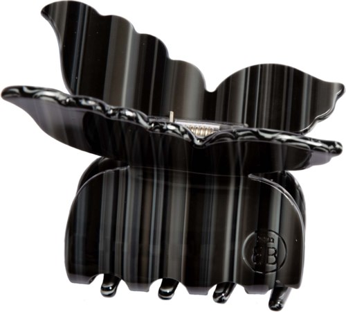 Eine schwarze Haarspange mit einem großen dekorativen Blatt oben.