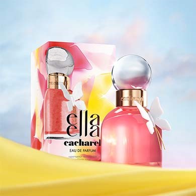 A pink perfume bottle with a round glass top, and a butterfly decoration, next to colorful packaging. The background is sky blue.