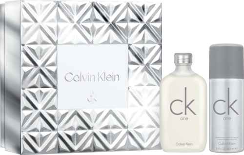 Calvin Klein ck one perfume gift set with a bottle and spray can, silver and white packaging with geometric patterns.