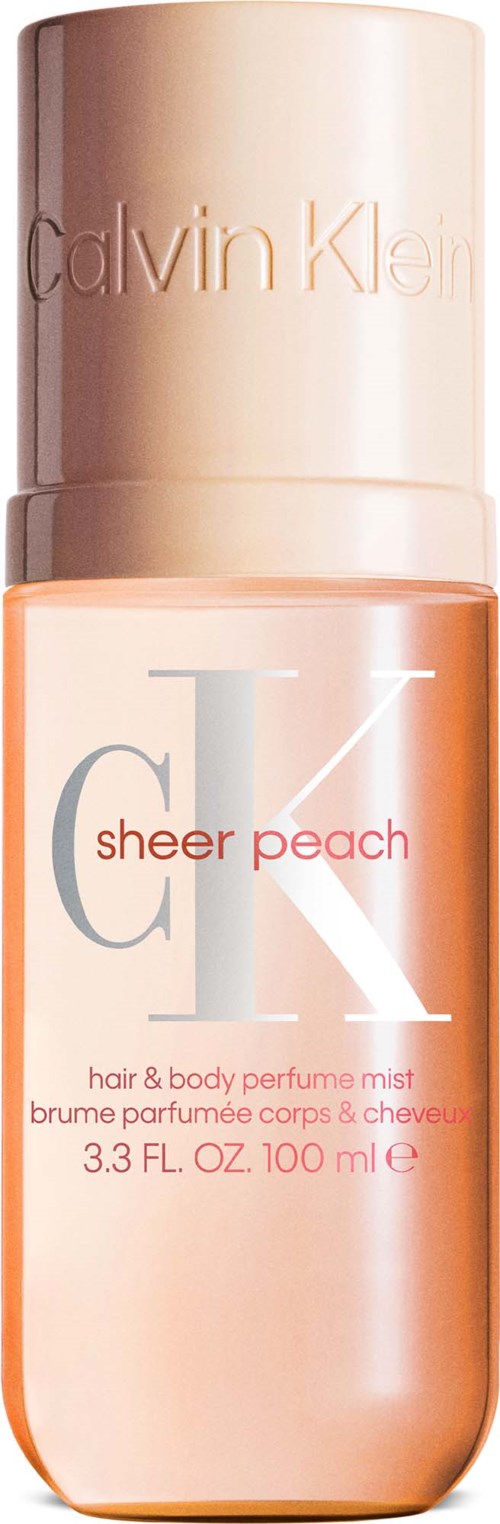 Calvin Klein sheer peach hår- og kroppsspray i en rosa sprayflaske.
