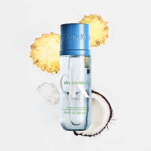 Calvin Klein silky coconut duftspray med kokos, ananas og kokosnøttskall rundt den.