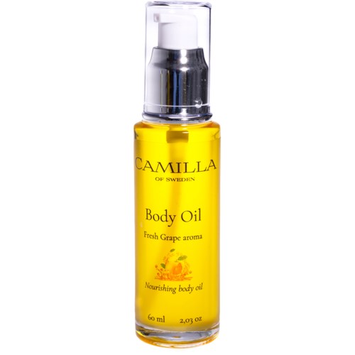 A yellow bottle of Camilla of Sweden body oil with a pump, labeled as having a fresh grape aroma.