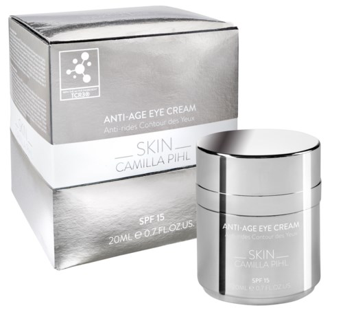 En silverburk med en box bakom, båda märkta som anti-aging ögonkräm med SPF 15, för hudvård.