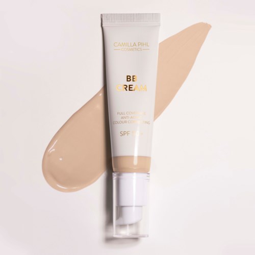 A tube of Camilla Pihl Cosmetics Be Cream with SPF, beige color, and a matching smear behind it.