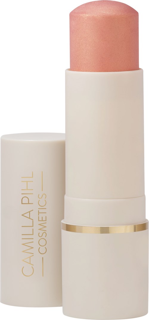 Een beige lippenstift met gouden ringdetail, gemerkt Camilla Phil Cosmetics, met de dop ernaast.