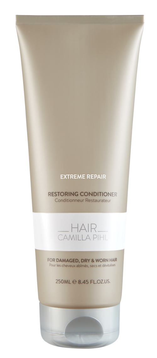 Een beige tube met haarconditioner labeled 'Extreme Repair' voor beschadigd, droog en verzwakt haar, bevat 250 ml.