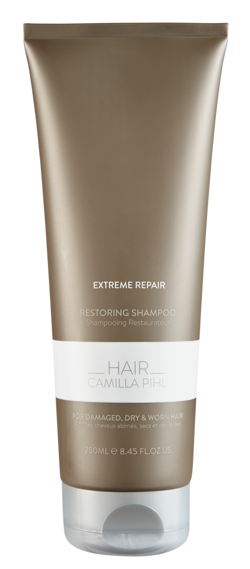 Een shampoo fles met de tekst 'Extreme Repair' voor beschadigd, droog en grof haar, wit en bruin.