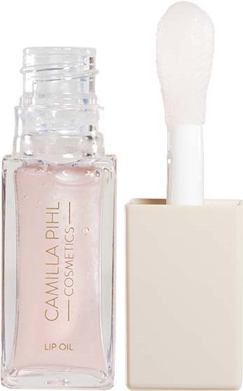 Eine kleine klare Flasche Lippenöl mit einem weißen Applikatorpinsel in einem quadratischen Behälter.