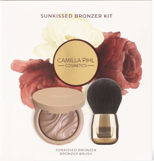 Cosmetics set includes a bronzer and a brush with a floral background. The brand is Camilla Pihl Cosmetics.