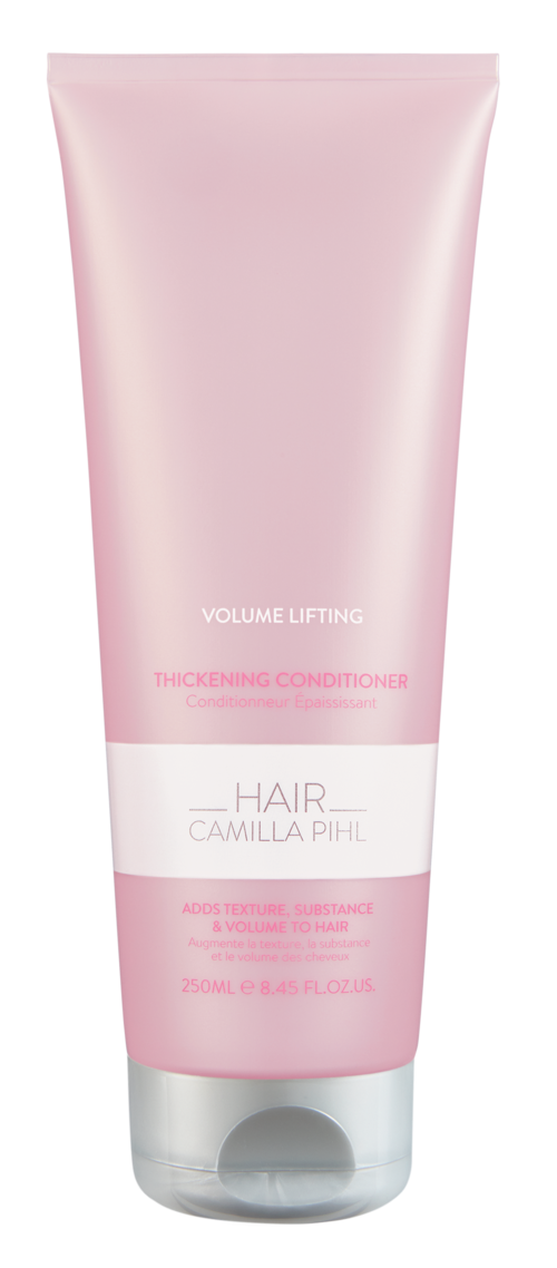 Roze haarconditioner tube met witte en roze label, geeft aan dat het voor volumeversterking en verdikking is.