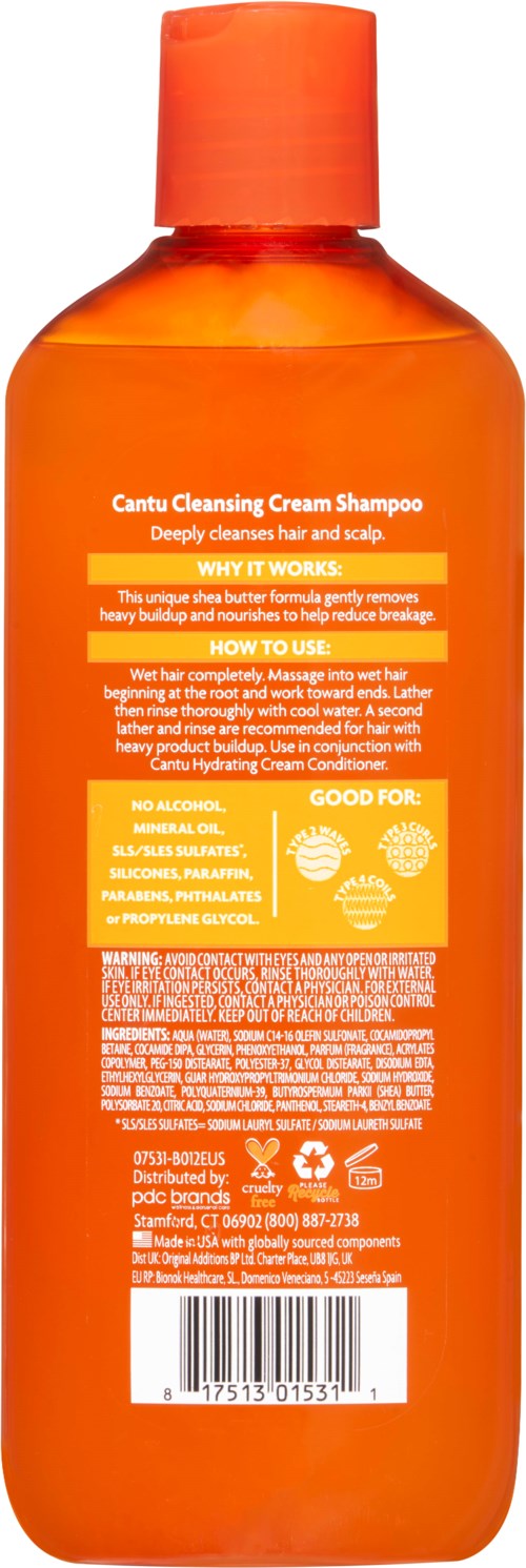 Een oranje fles Cantu Reinigingscrème Shampoo met schroeffles, grotendeels gevuld, met informatieve label.