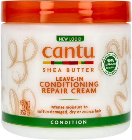 Een witte pot met oranje deksel, gemerkt Cantu Shea Butter Leave-In Conditioning Repair Cream, voor droog en beschadigd haar.