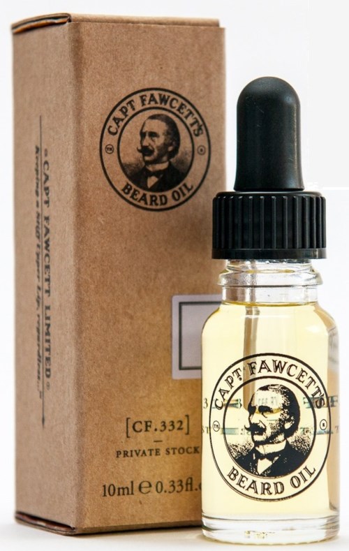 A small beard oil bottle with a black dropper cap and a beige label, next to a cardboard box.