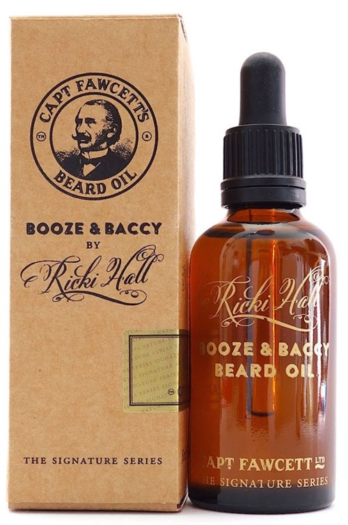 A small brown bottle with a black lid and dropper, labeled as beard oil, beside a matching box.