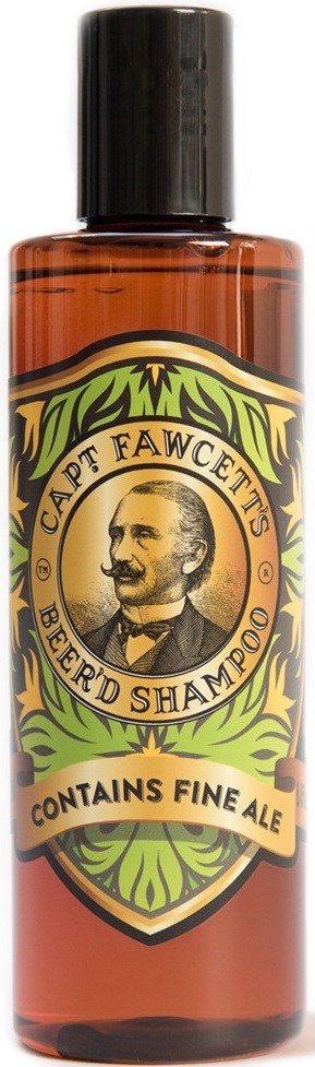 En liten brun flaska med etikett som säger 'Beer'd Shampoo' och 'Contains Fine Ale', med en mans porträtt och gröna dekorativa kanter.