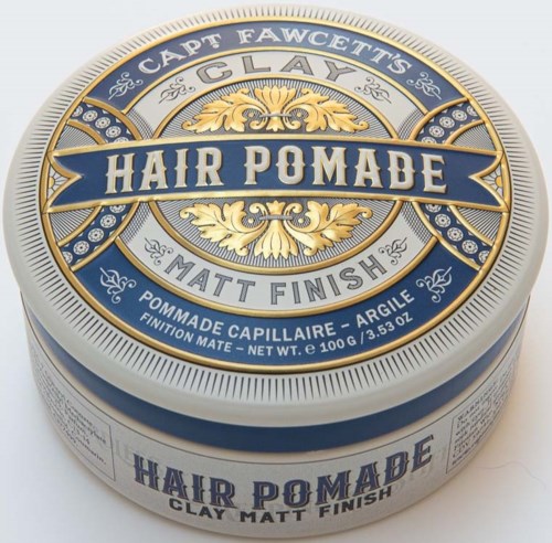 A round container of hair pomade with blue, gold, and white colors, labeled for matte finish and clay.
