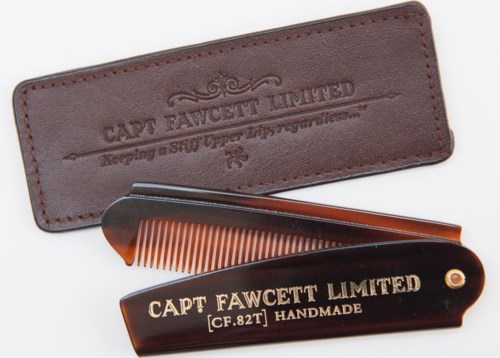 A leather case, a black comb, and a folding comb with the text "CAPT FAWCETT LIMITED".
