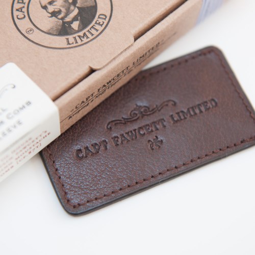 Leather tag with embossed text 'CAPPY BAUWET LIMITED' and decorative design.
