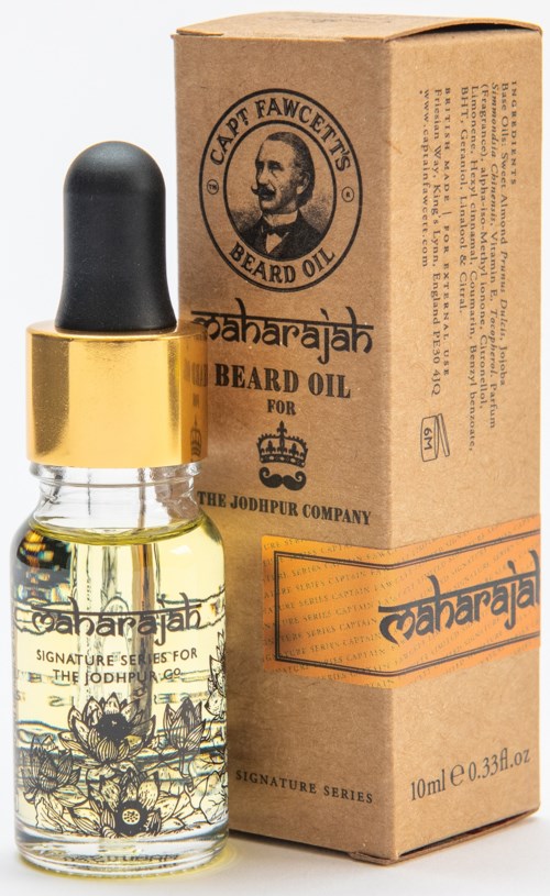 A small bottle of beard oil with a dropper, next to a brown box with a logo and text.