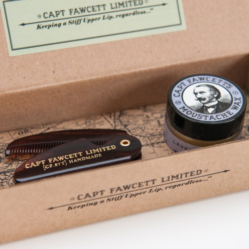 A grooming kit with a brush, a small jar, and packaging featuring Captain Fawcett's logo and name.