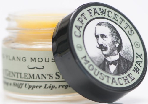 A container with a label showing a man with a mustache, and text about a men's grooming product.