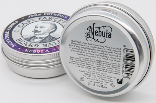 Two round tins with silver lids, one showing a label with text and a barcode, the other with a picture of a man.
