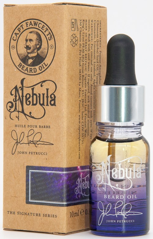 A small bottle of beard oil with a dropper and a cardboard box, labeled 'Nebula' and 'John Petrucci'.