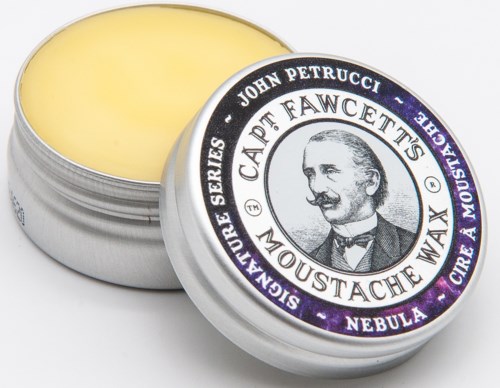 A round tin of moustache wax with a black and white label featuring a man's portrait and product details.