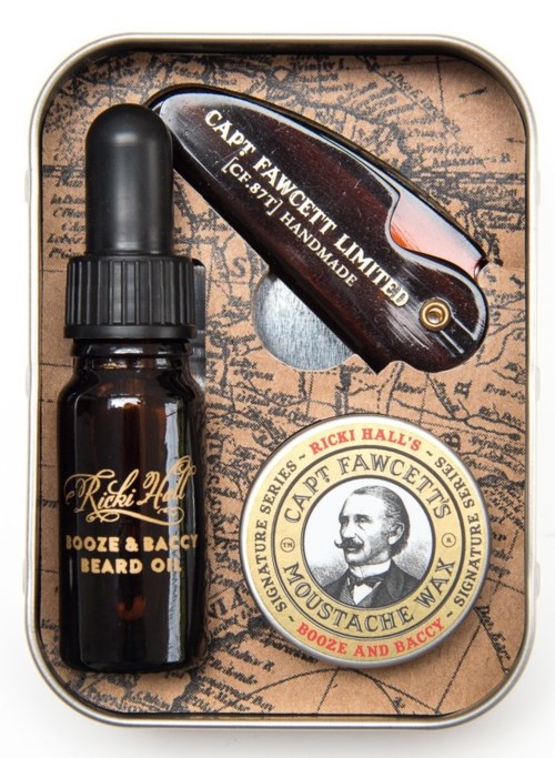 A grooming set includes beard oil, a small bottle with a dropper, a multi-tool with 'CAPT. FAWCETT LIMITED' label, and a round tin.