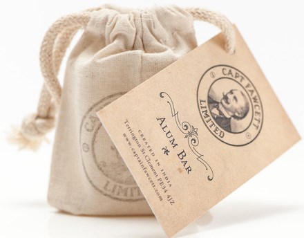 Small beige drawstring pouch with a label reading 'Alum Bar' and 'Captain Fawcett Limited' attached.