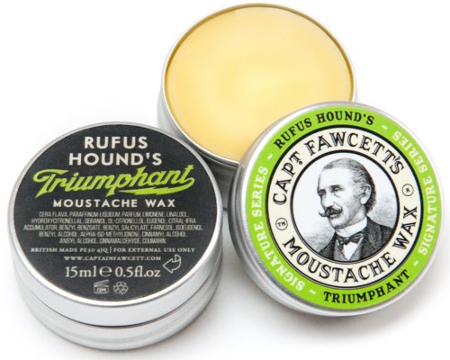 A small round tin of Rufus Hound's Triumphant moustache wax with a label showing a man's face and green and black text.