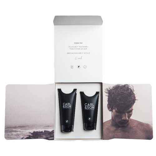 Two black tubes labeled 'Carl & Son' inside a white box with images of a man and an outdoor scene.