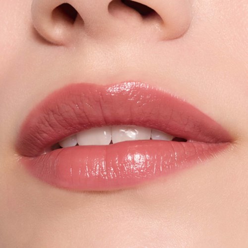 Close-up of lips with pink gloss and teeth slightly showing.