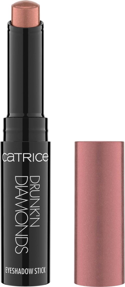 A black stick with a pinkish beige top, labeled Catrice Drunken Diamonds Eyeshadow Stick, with pink cap nearby.