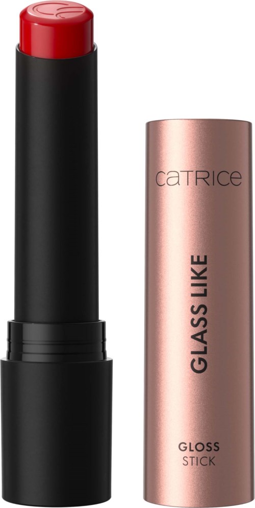 A red lipstick in a black tube placed next to a rose gold cylindrical container labeled 'GLASS LIKE,' 'GLOSS STICK,' and 'CATRICE.'