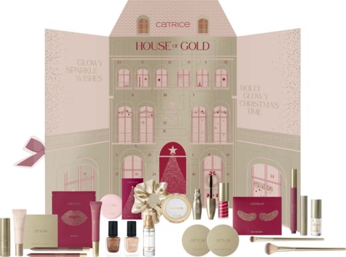 A festive makeup set with various products, a large Christmas house backdrop, and holiday-themed decorations and packaging.