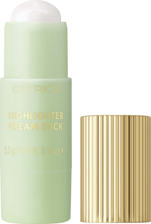 Een halverwege open lichtgroene stick met witte creme erin en een gouden geribbelde dop ernaast.
