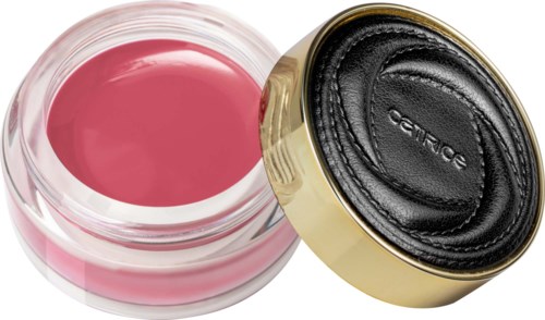 A pink gel inside a transparent container, next to a black and gold compact case.