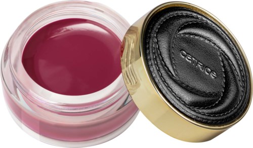 Een klein potje roze nagellak naast een zwart-goud deksel spiegel. De spiegel is gesloten.