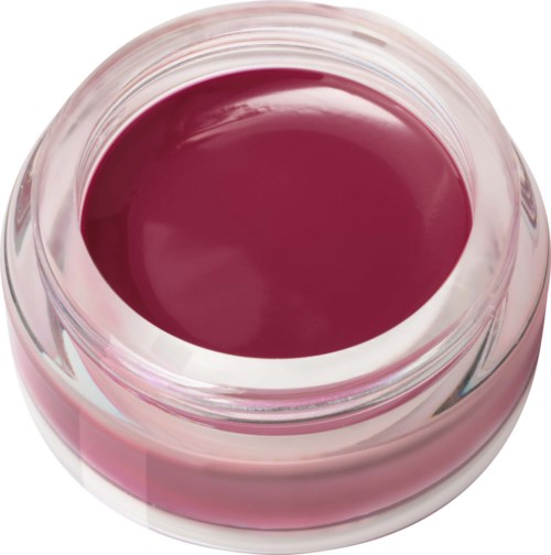 Kleine glazen pot gevuld met donkerroze of magentakleurige crème of gel.
