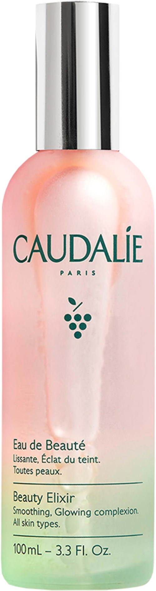 A pink and green bottle with a silver cap, labeled Caudalie, promotes a beauty elixir for all skin types.