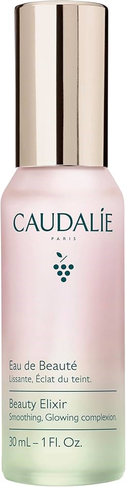 A pink and green bottle with a gold cap labeled Caudalie Paris, Beauty Elixir, for smoothing and glowing skin.
