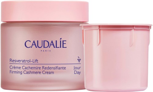 A pink jar and a matching container for Caudalie skincare product with blue text on the front.