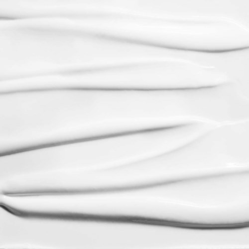 Smooth white surface with gentle, flowing lines and soft shadows creating a calm, elegant look.